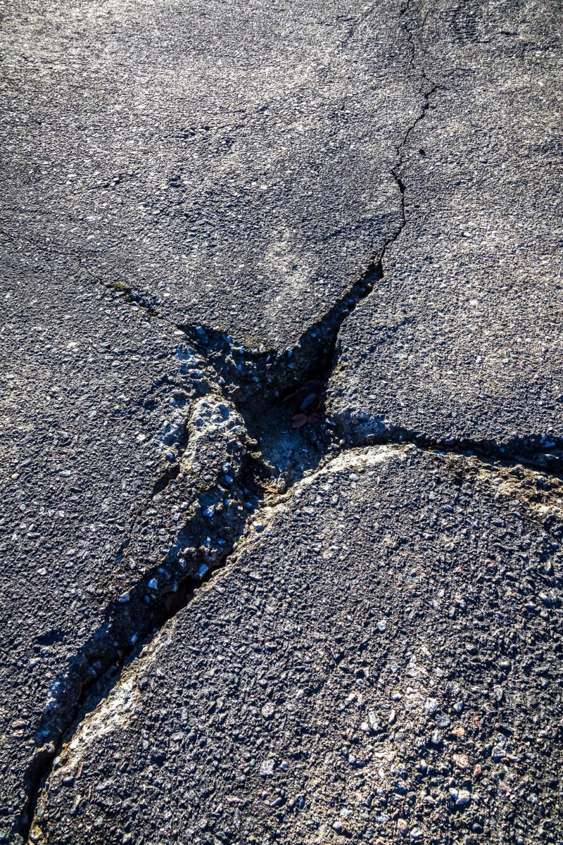 Cracked pavement surface with one crack filled and sealed